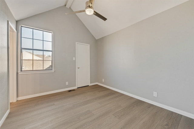 empty room with ceiling fan, lofted ceiling with beams, and light wood-type flooring