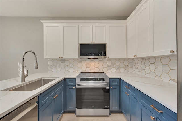 kitchen featuring sink, stainless steel appliances, tasteful backsplash, blue cabinets, and white cabinets