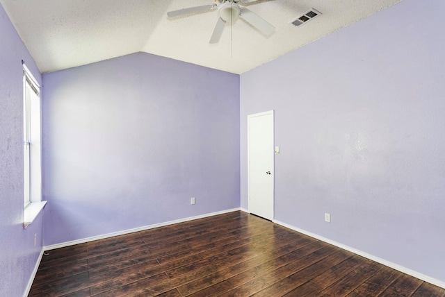 spare room featuring ceiling fan, dark hardwood / wood-style floors, a textured ceiling, and vaulted ceiling