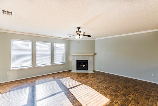 unfurnished living room featuring dark hardwood / wood-style flooring, ceiling fan, a textured ceiling, and a healthy amount of sunlight