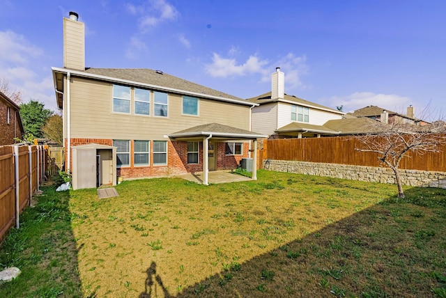 back of house featuring a lawn and a patio