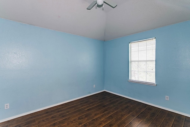 empty room with ceiling fan and dark hardwood / wood-style flooring