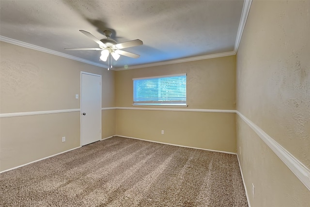 carpeted spare room with ceiling fan and ornamental molding