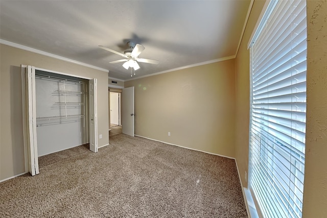 unfurnished bedroom with ceiling fan, a closet, carpet floors, and ornamental molding