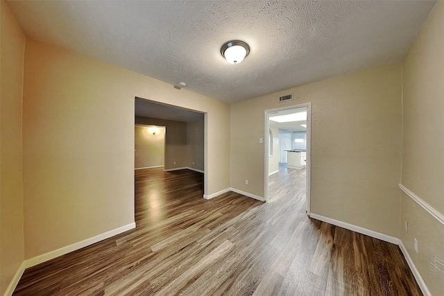 spare room with hardwood / wood-style flooring and a textured ceiling