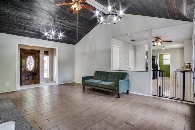 entrance foyer with lofted ceiling, ceiling fan with notable chandelier, and light hardwood / wood-style flooring