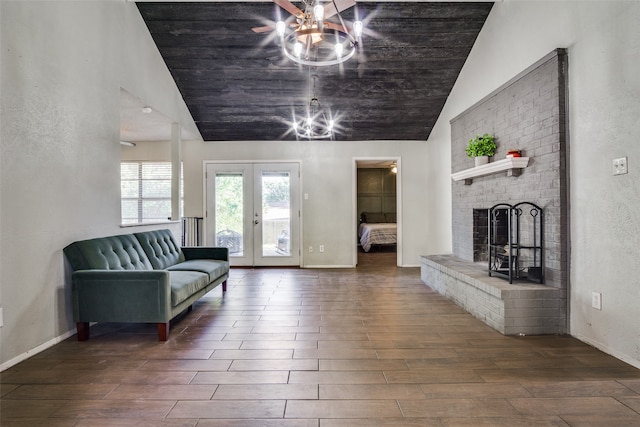 interior space featuring wooden ceiling, lofted ceiling, a brick fireplace, dark wood-type flooring, and french doors