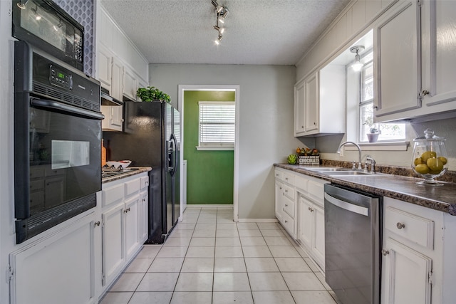 kitchen featuring black appliances, sink, a healthy amount of sunlight, and white cabinets