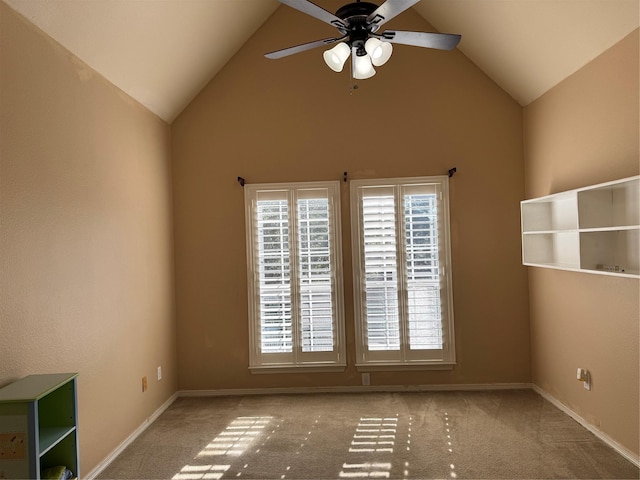 unfurnished room with ceiling fan, high vaulted ceiling, and light colored carpet