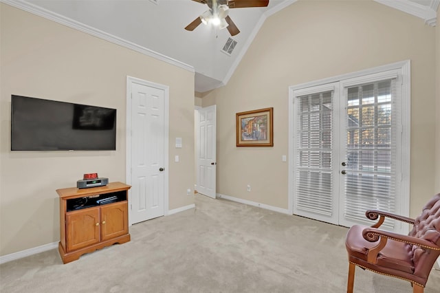 living area with light colored carpet, vaulted ceiling, ceiling fan, and ornamental molding