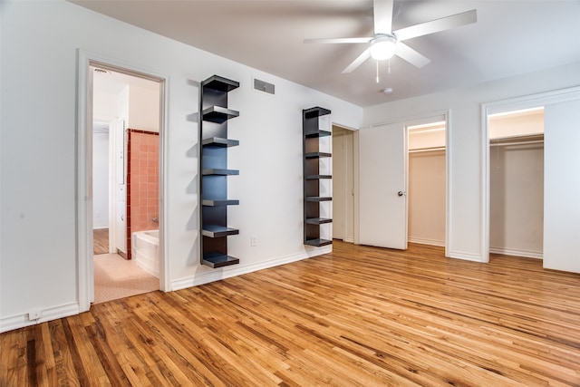 unfurnished bedroom with ceiling fan, light hardwood / wood-style floors, and ensuite bath