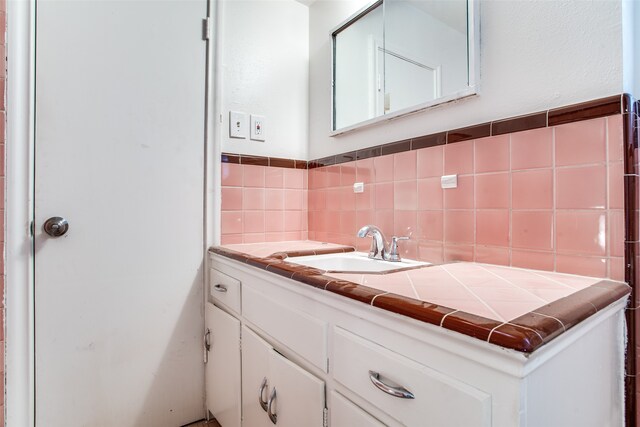 bathroom with decorative backsplash and vanity