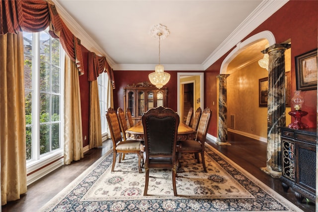 dining space with ornamental molding, a notable chandelier, dark hardwood / wood-style floors, and plenty of natural light