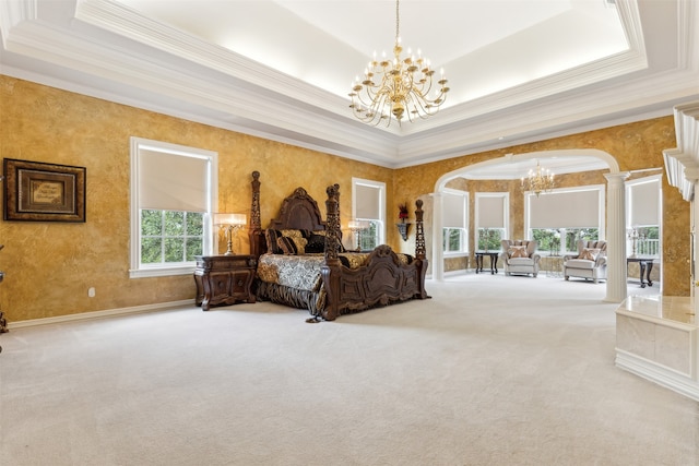 bedroom featuring ornate columns, carpet floors, ornamental molding, and a tray ceiling