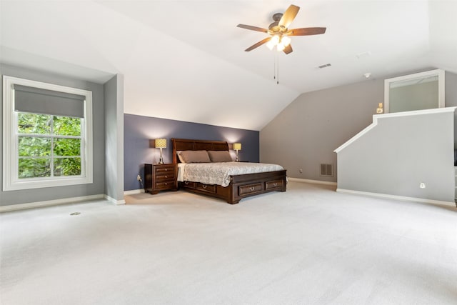 bedroom with ceiling fan, lofted ceiling, and light colored carpet