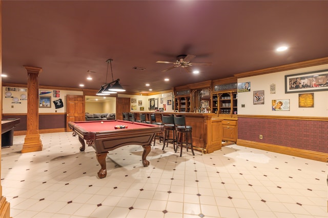 game room with ceiling fan, bar area, crown molding, ornate columns, and billiards