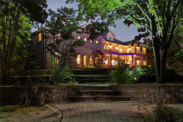 view of back house at dusk