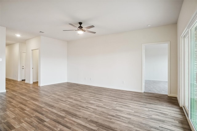 unfurnished room with ceiling fan and light wood-type flooring