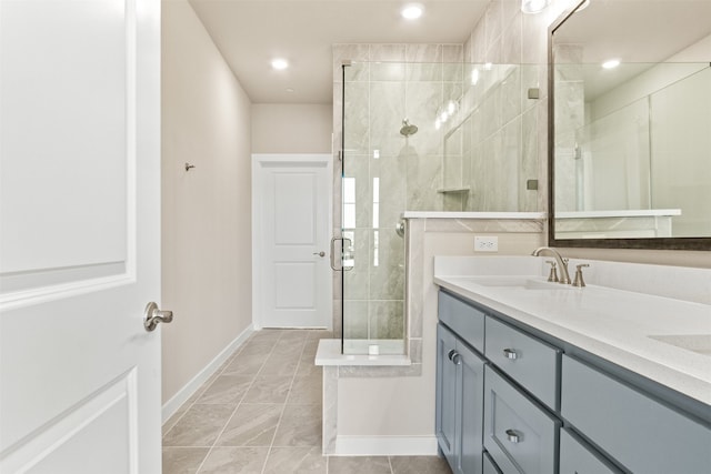 full bath with recessed lighting, a sink, baseboards, double vanity, and a stall shower