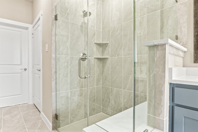 bathroom with a shower stall, vanity, and tile patterned floors