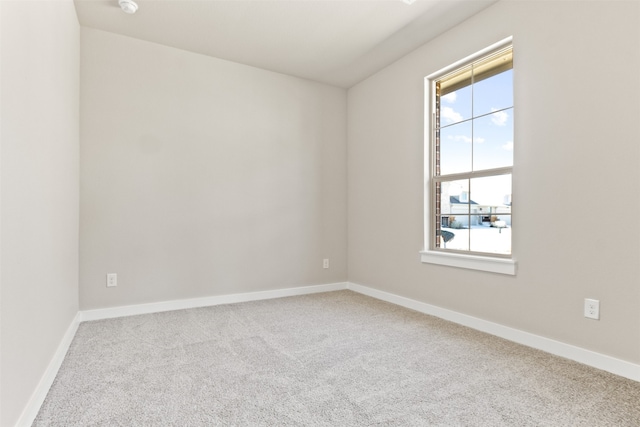 empty room featuring carpet flooring and baseboards