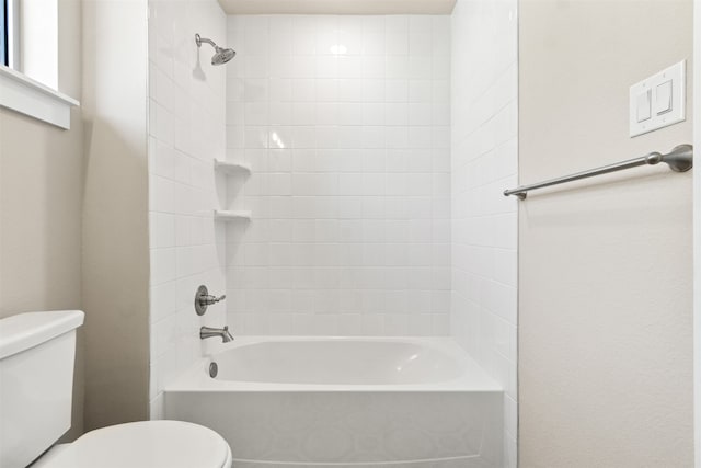 bathroom featuring tub / shower combination and toilet