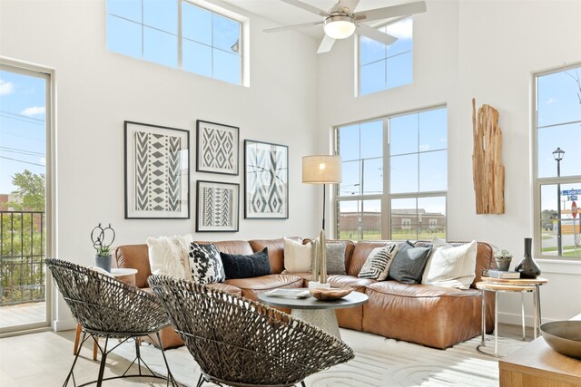 living room with a healthy amount of sunlight and a towering ceiling