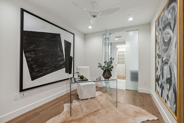 home office featuring hardwood / wood-style floors and ceiling fan