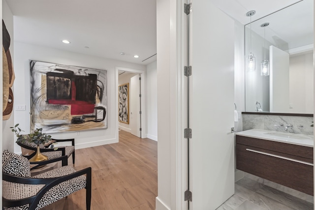 bathroom featuring hardwood / wood-style flooring and vanity