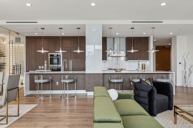 living room featuring light hardwood / wood-style floors and sink