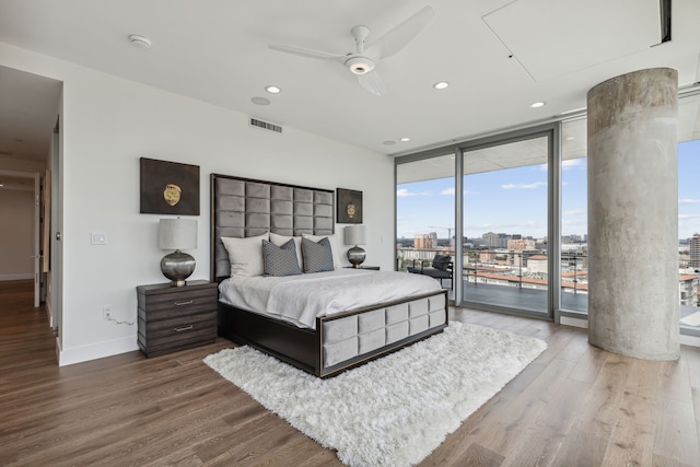 bedroom featuring hardwood / wood-style flooring, access to exterior, ceiling fan, and floor to ceiling windows