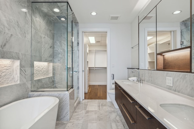 full bathroom with toilet, vanity, and shower with separate bathtub