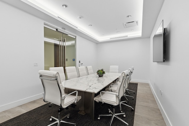 dining space featuring a raised ceiling