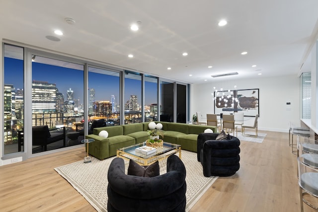 living room with floor to ceiling windows and light hardwood / wood-style flooring