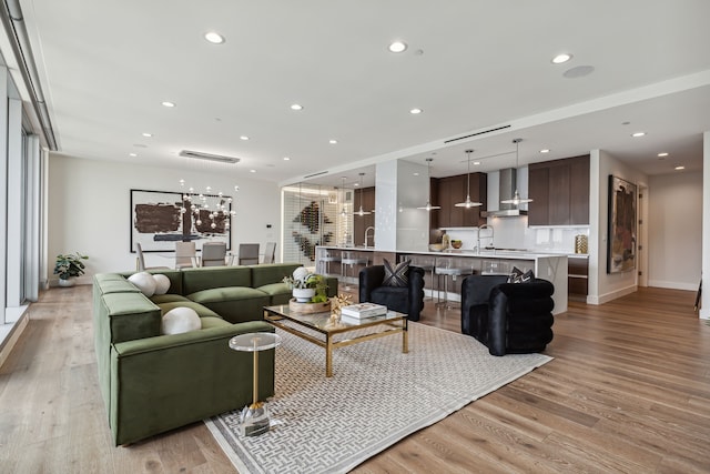 living room featuring light hardwood / wood-style floors and sink