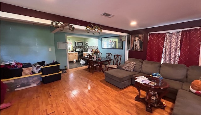 living room featuring wood-type flooring and beam ceiling