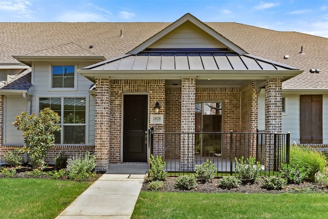 view of front of house featuring a front yard and covered porch