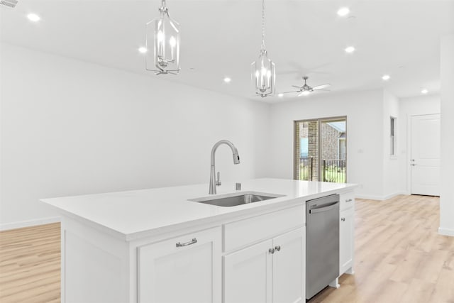 kitchen with a center island with sink, white cabinetry, light wood-type flooring, sink, and stainless steel dishwasher