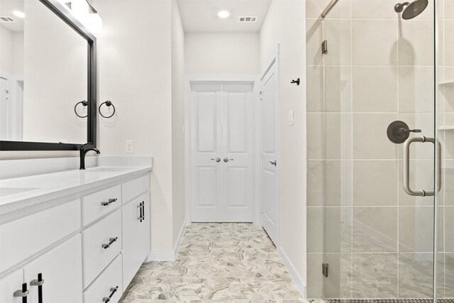 bathroom featuring vanity and an enclosed shower