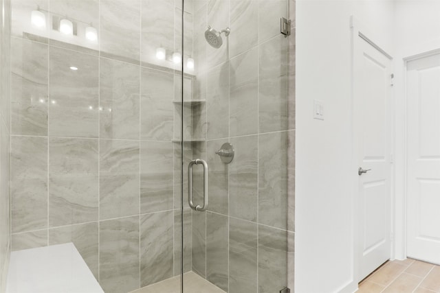 bathroom featuring tile patterned flooring and a shower with shower door