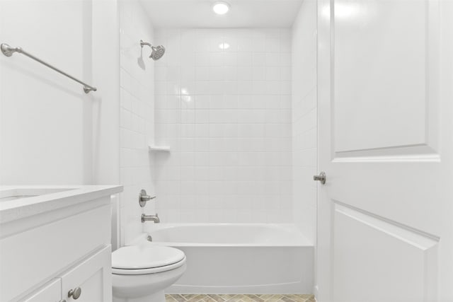 full bathroom with tile patterned flooring, vanity, toilet, and tiled shower / bath