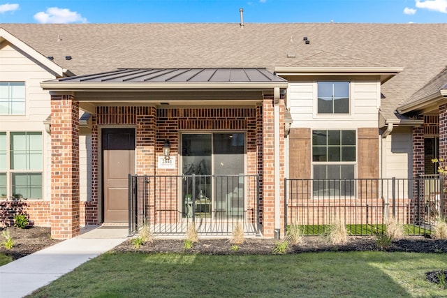 view of exterior entry with a yard