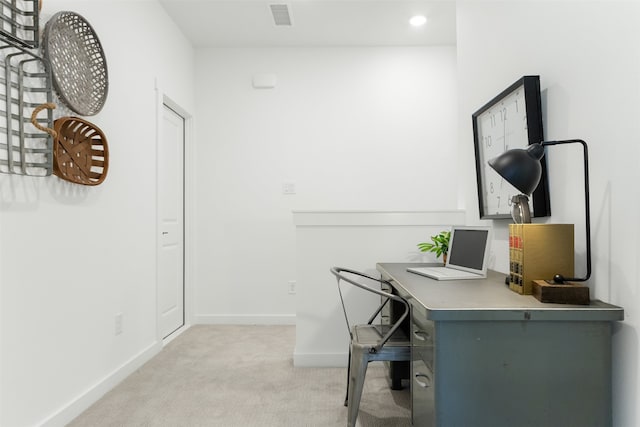 carpeted office space with built in desk