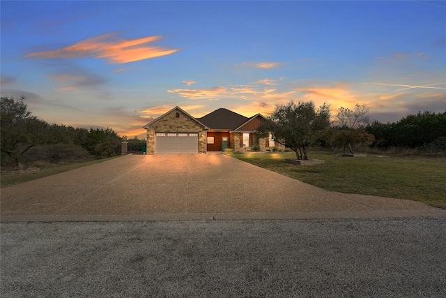 view of front of property with a garage and a lawn