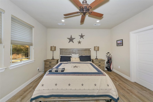 bedroom with light hardwood / wood-style flooring and ceiling fan