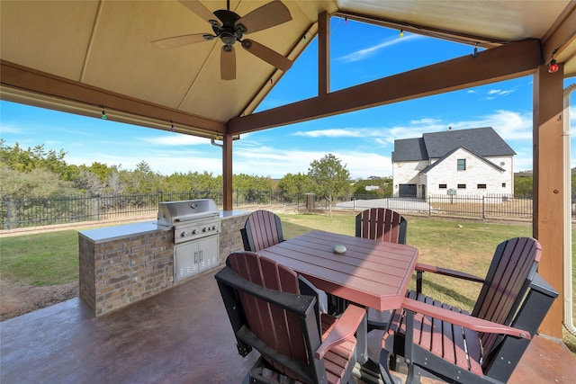 view of patio featuring an outdoor kitchen, area for grilling, and ceiling fan