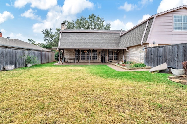 back of house featuring a yard and a patio area