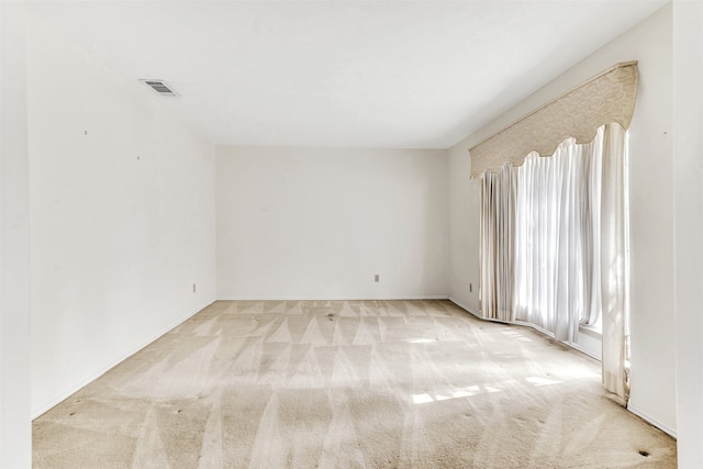 unfurnished room with light colored carpet