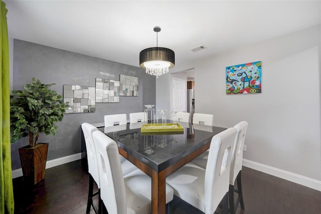 dining area with dark hardwood / wood-style floors