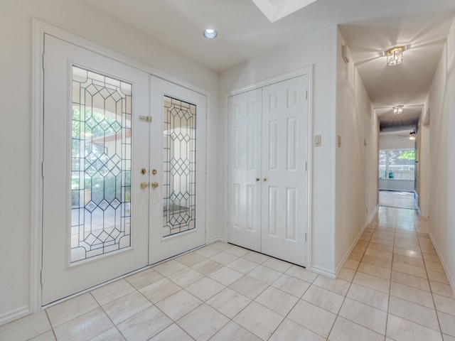 tiled foyer entrance with french doors and a wealth of natural light